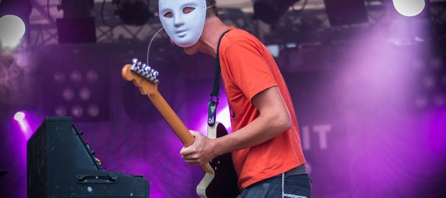 a guy playing guitar and synth